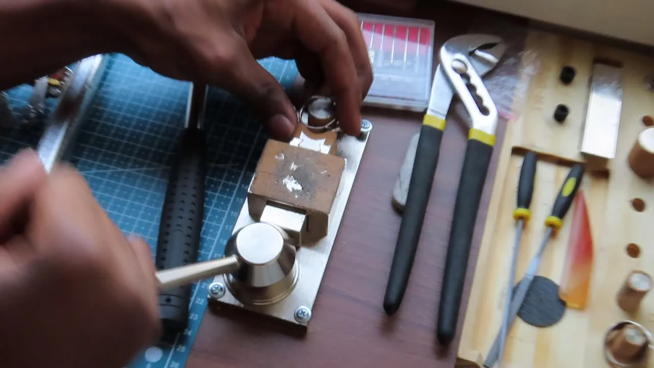 A Rawform ring being shaped by hand